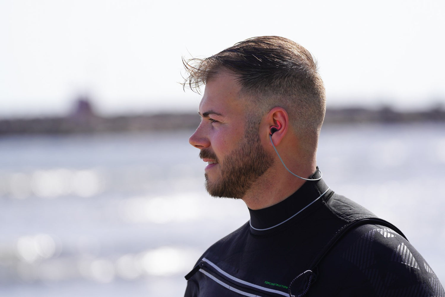 Surfer wearing SurfEars4.0